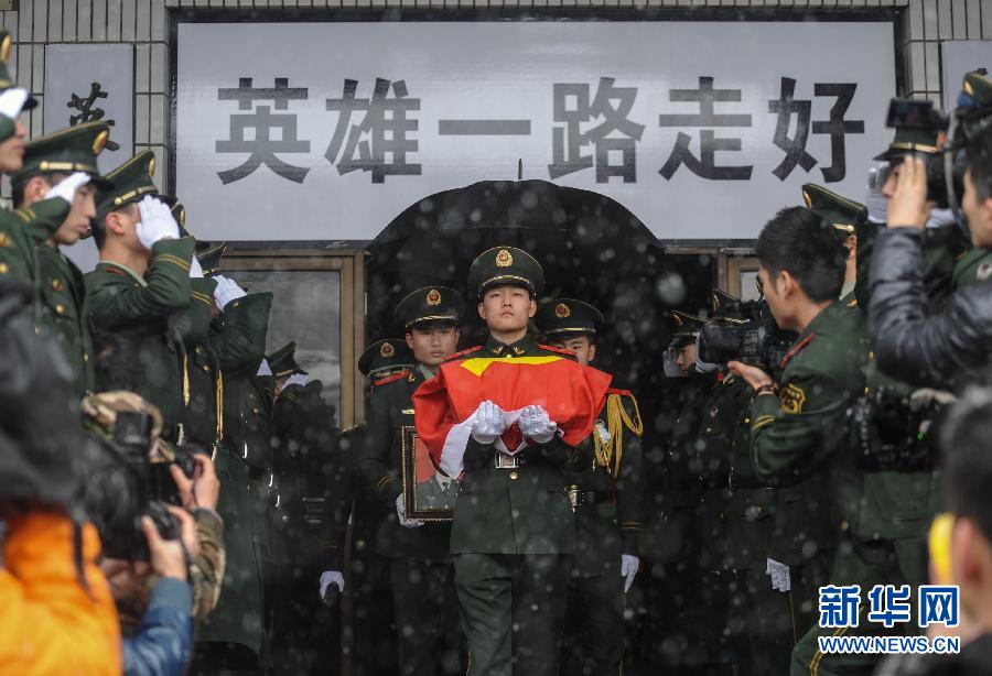 1月4日,在杭州萧山殡仪馆,消防战士捧着一名烈士的骨灰走出追悼厅